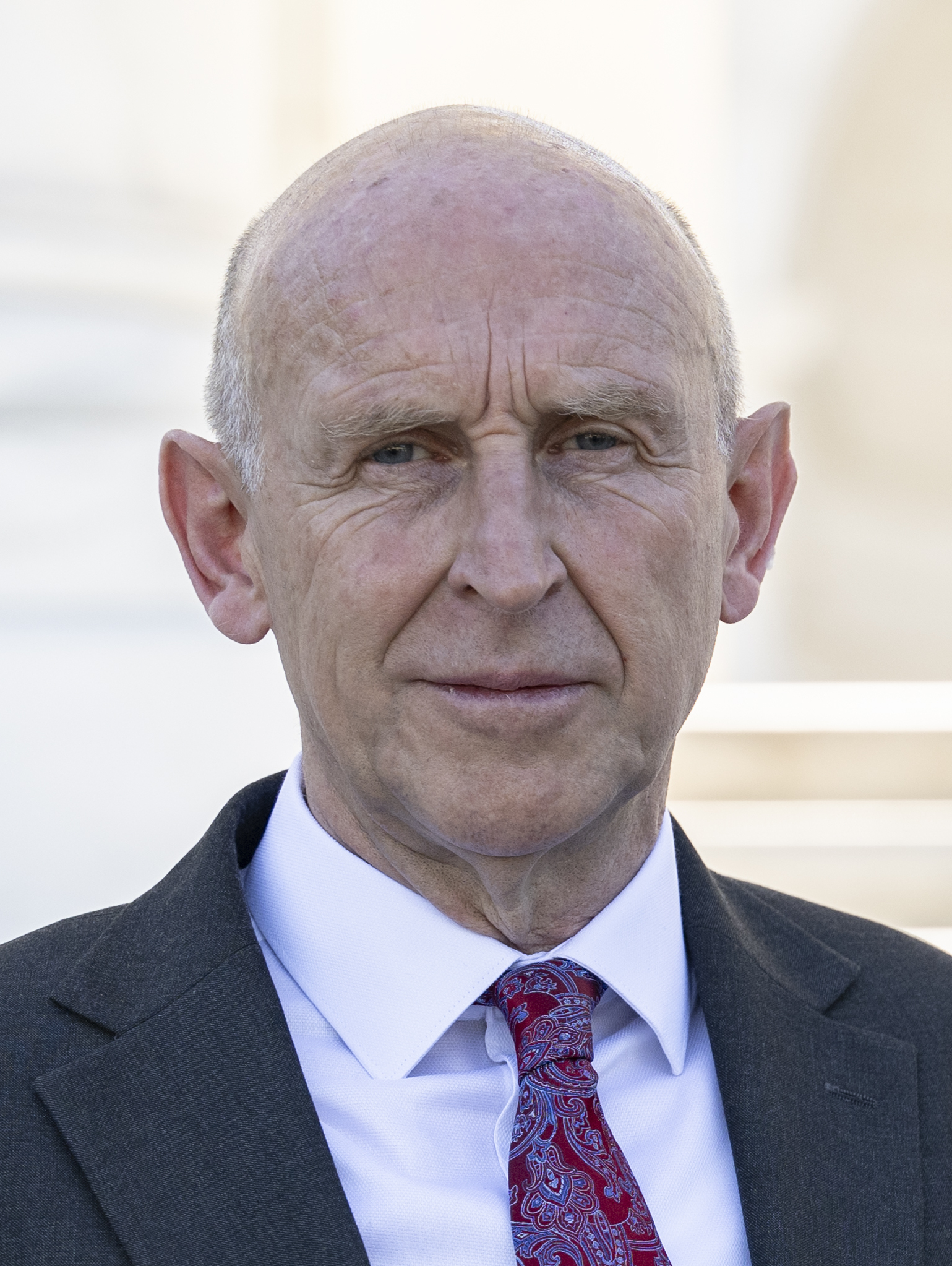 John Healey, UK Defence Secretary, at Arlington National Cemetery in July 2024 — days into the tenure in which he signed the buyback.