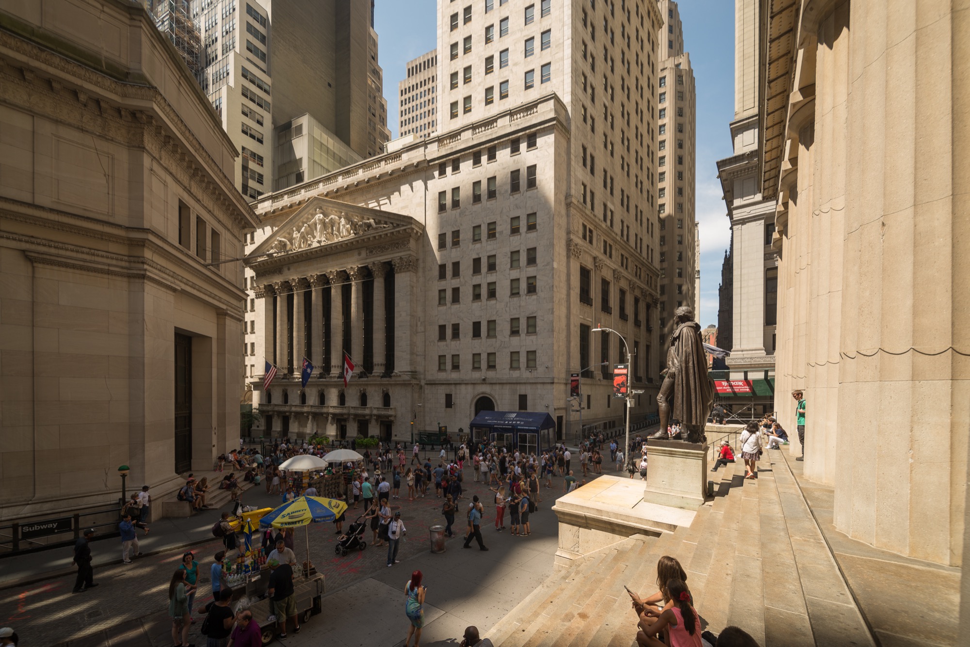 The New York Stock Exchange seen from the steps of Federal Hall, George Washington’s statue at right — the canyon the Financial District’s office towers were built to serve.