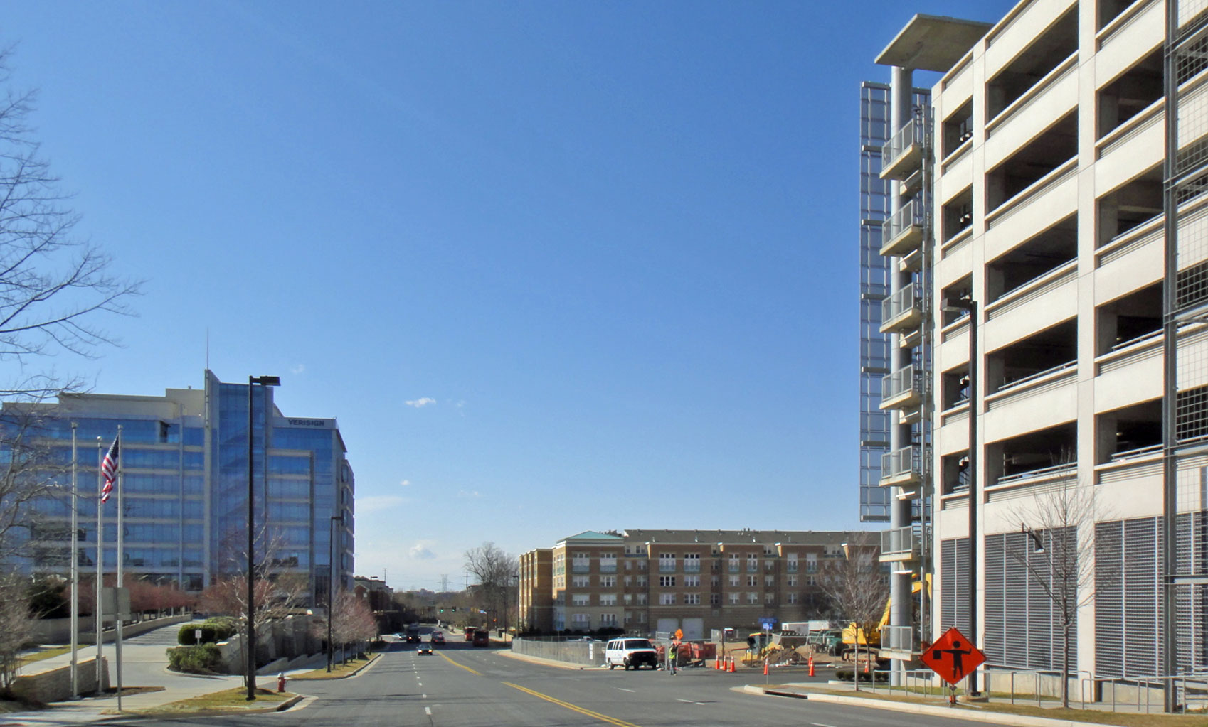 Reston Town Center in Virginia — low brick and glass office blocks around a paved plaza with young street trees, under a pale winter sky.
