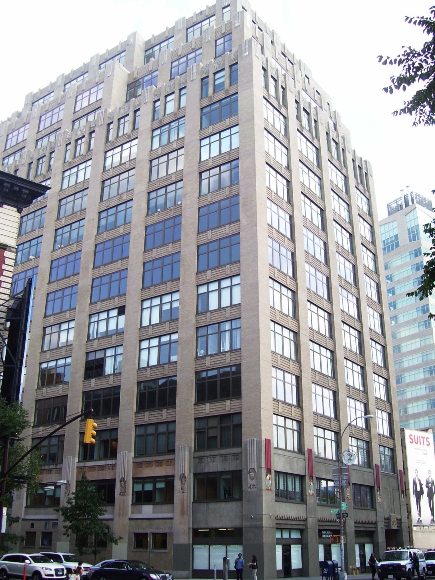 100 Avenue of the Americas — a 1920s printing-district loft building in the Hudson Square Properties portfolio, its window grid filling the block.