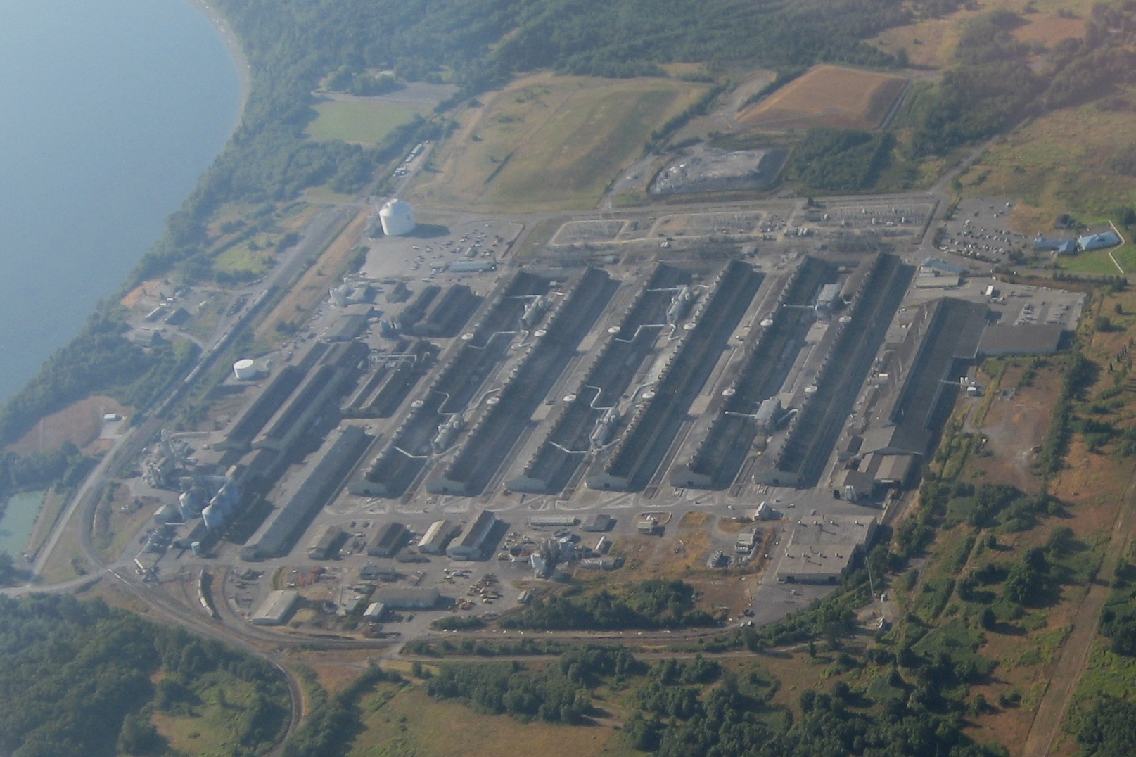 Aerial view of the Alcoa Intalco Works aluminum smelter at Ferndale, Washington — long parallel potline sheds beside the water.