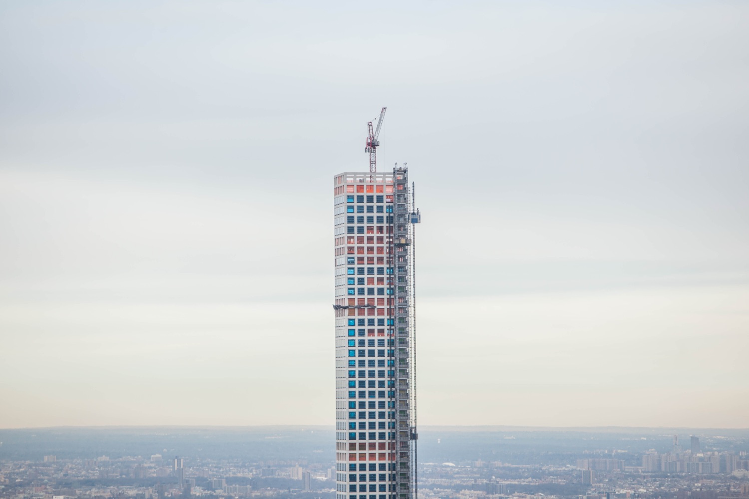 432 Park Avenue under construction in January 2015, its white concrete grid rising above the Midtown skyline.