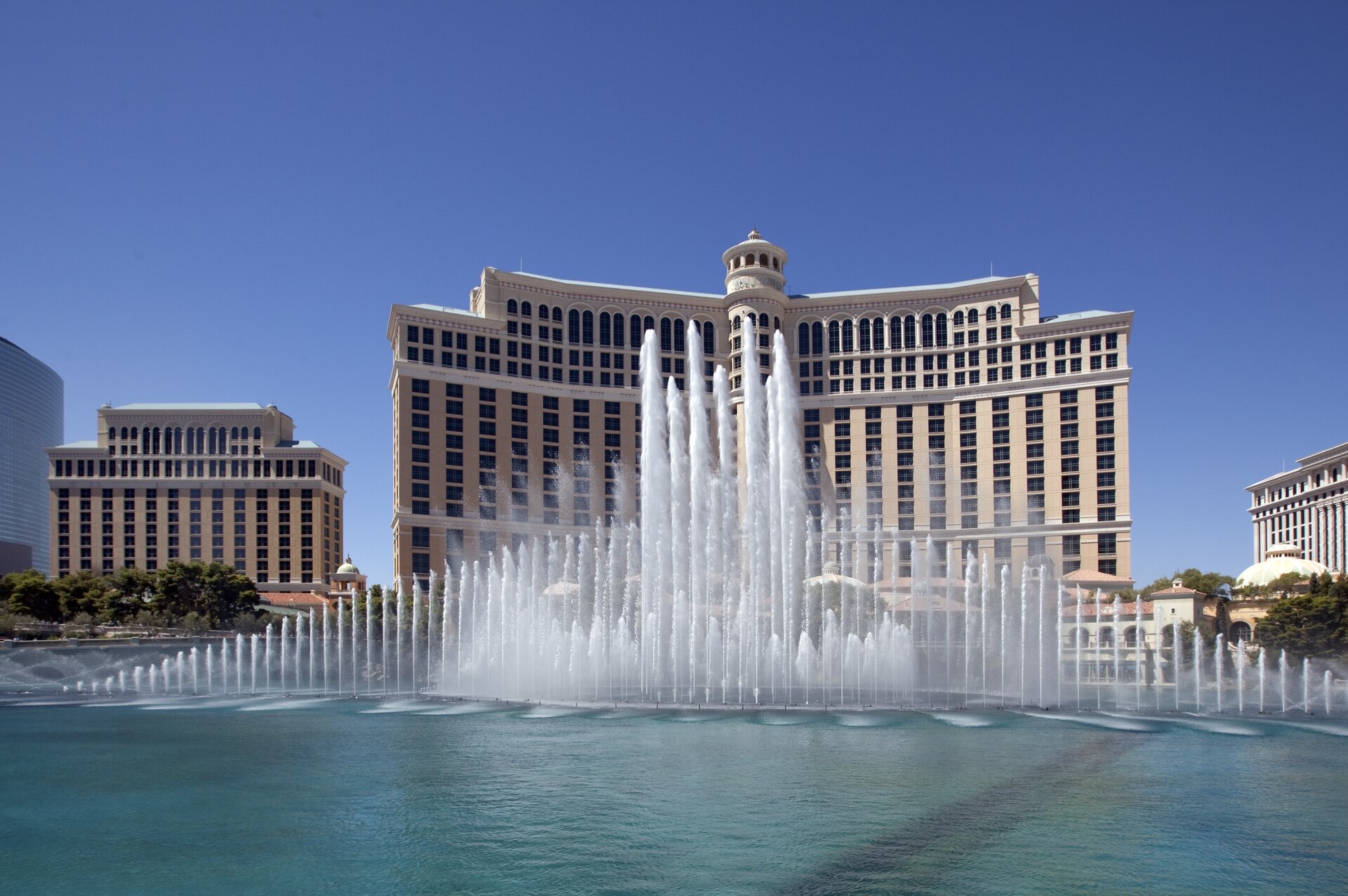 The Bellagio’s cream-coloured facade and towers on Las Vegas Boulevard, with the dancing fountains firing on the lake in front.
