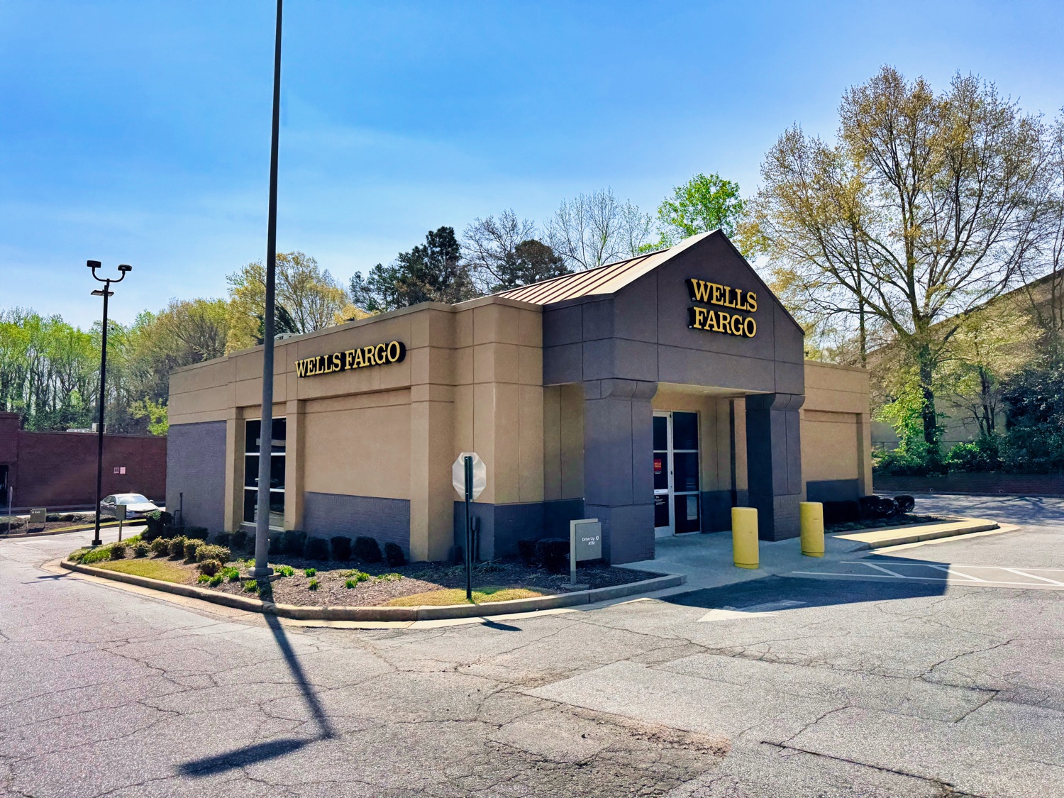 A modern Wells Fargo branch in Athens, Georgia — the stagecoach logo and red signage above the entrance.