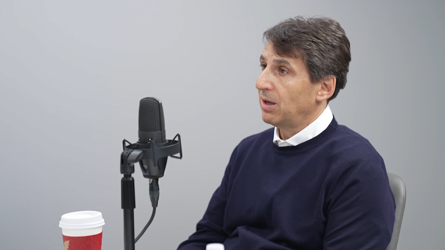 Marc Rowan, chief executive of Apollo Global Management, seated at a microphone during a 2024 Mercatus Center interview.