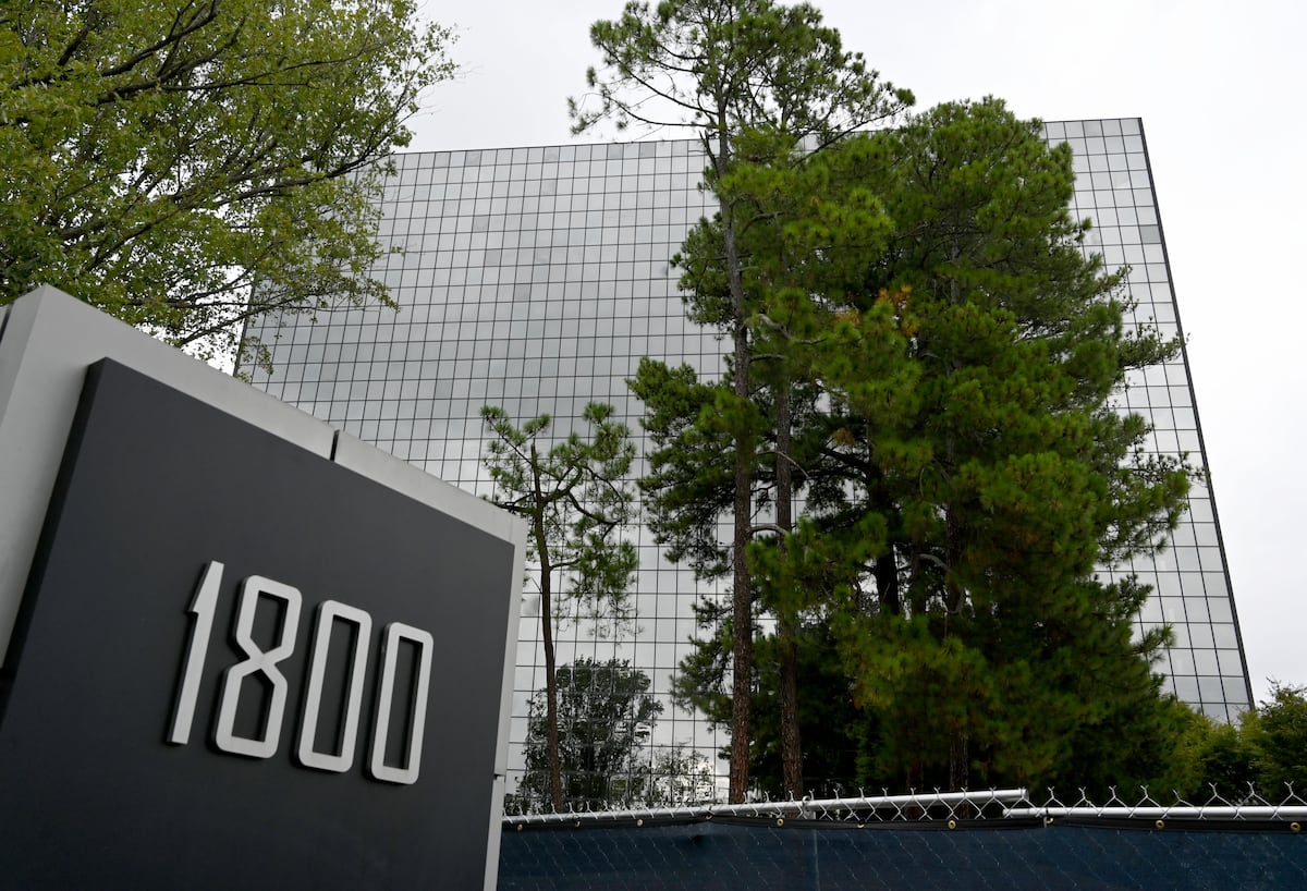 The tower and its 1800 address marker behind a construction fence