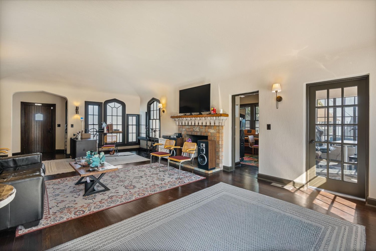 Fireplace, dark wood floors and glazed doors inside the Paul Kindler House.