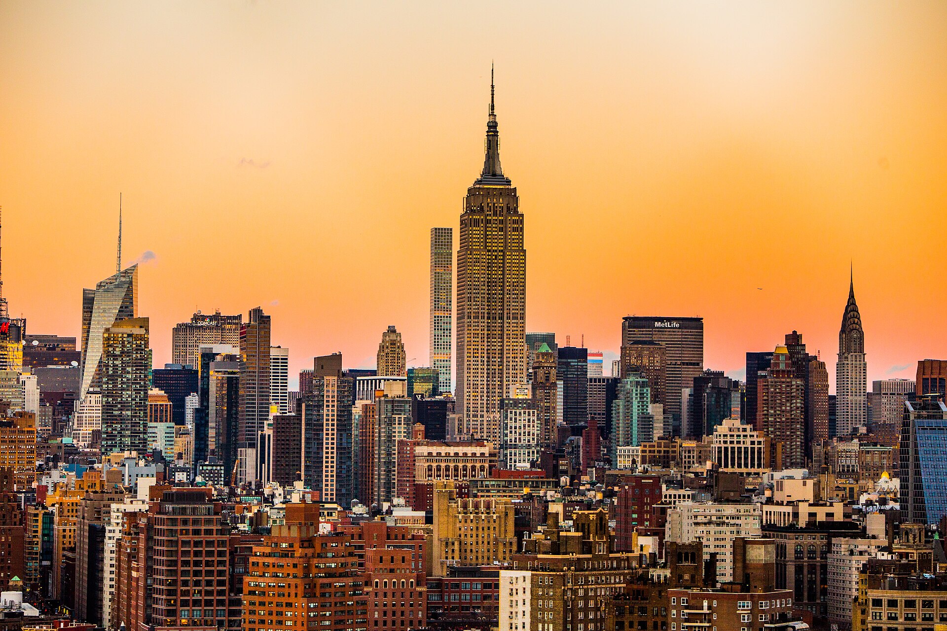 The whole Empire State Building against an orange sunset sky, from Top of the Rock